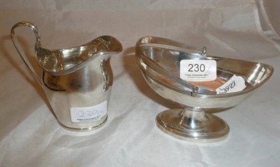 Lot 230 - A George V silver helmet shape cream jug with reeded edge, Chester 1924; a similar boat shape sugar