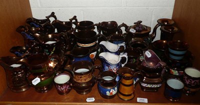 Lot 250 - A shelf of copper and pink lustre jugs, mugs, tea pot etc
