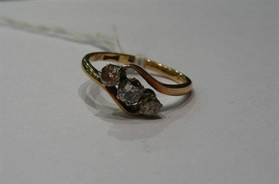 Lot 262 - A diamond three stone twist ring