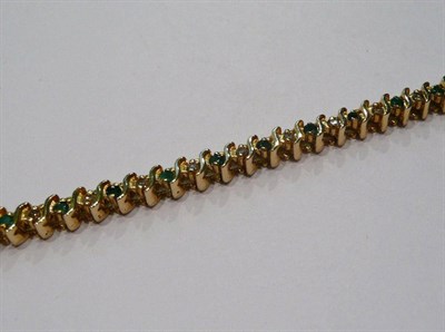 Lot 301 - An emerald and diamond bracelet, stamped '14k'