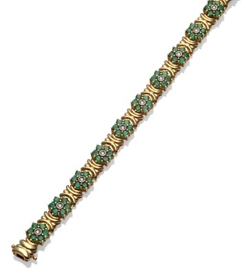 Lot 226 - A Diamond and Emerald Bracelet, thirteen clusters of a round brilliant cut diamond in a white...