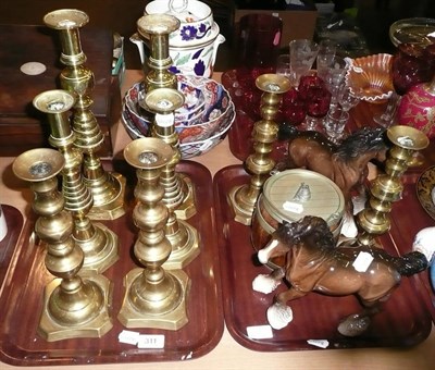 Lot 311 - Four pairs of brass candlesticks, a pair of Beswick horses and a biscuit barrel, on two trays