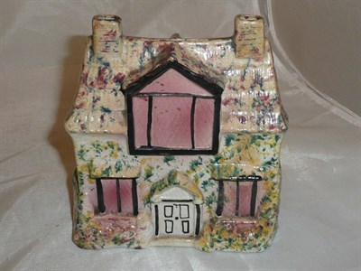 Lot 327 - A Staffordshire money box with sponged decoration