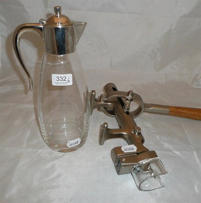 Lot 332 - A claret jug with silver mount and a bench top corkscrew