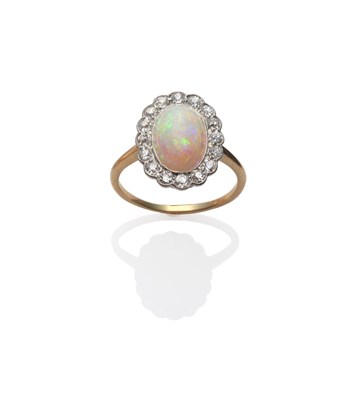 Lot 229 - An Opal and Diamond Cluster Ring, an oval cabochon opal within a border of old cut diamonds, in...