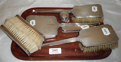 Lot 340 - Silver backed dressing table hand mirror, two hair brushes and two clothes brushes, glass pill...