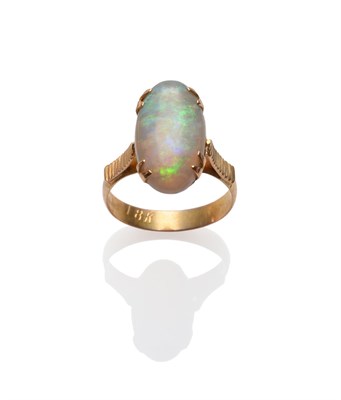 Lot 234 - An Opal Ring, the oval cabochon opal in a claw setting to linear decorated shoulders on a plain...
