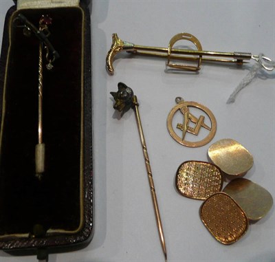 Lot 389 - A pair of 9ct gold cuff links, a ruby set stick pin, a 9ct gold stock pin as a hunting crop and...