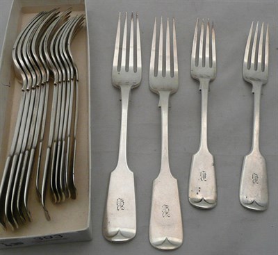 Lot 393 - A set of eight George V silver fiddle pattern table forks and eight dessert forks, London 1924,...