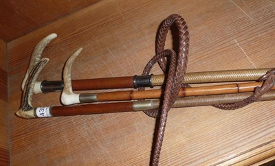 Lot 439 - A hunting whip with antler handle and silver mount and leather thong and two smaller riding crops