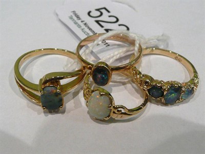 Lot 522 - A 9ct gold black opal ring,Two 9ct gold opal triplet rings and an opal ring stamped '22ct'