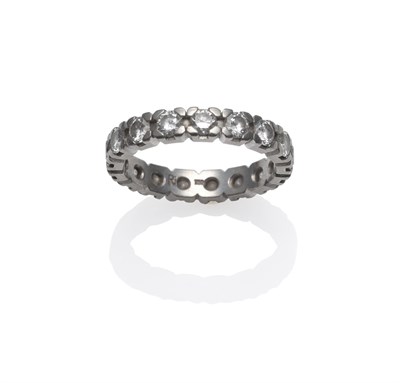 Lot 248 - A Diamond Eternity Ring, seventeen round brilliant cut diamonds in white claw settings, total...
