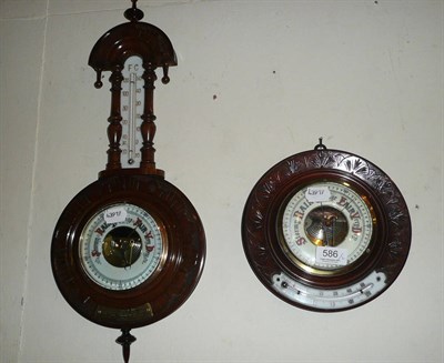 Lot 586 - A Victorian small aneroid barometer/thermometer in a walnut banjo case and another in a...