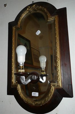 Lot 587 - A wall mirror with gilt mounts and light