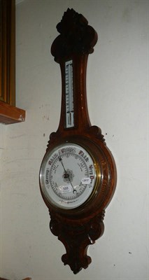 Lot 588 - A Victorian aneroid barometer/thermometer in an oak banjo case