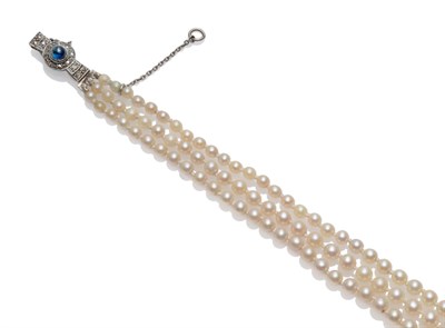 Lot 255 - A Cultured Pearl Necklace, three rows of graduated cultured pearls knotted to a bow shaped cabochon