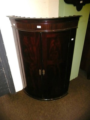 Lot 613 - Georgian mahogany bow front corner cupboard