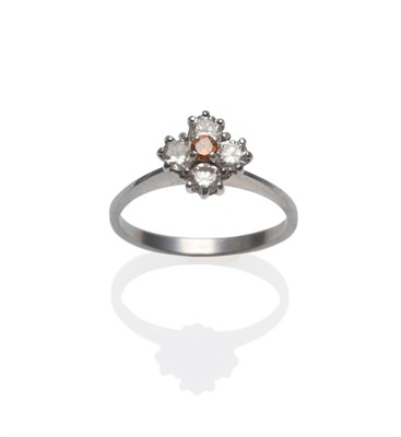 Lot 256 - A Diamond Cluster Ring, an orangey-brown round brilliant cut diamond within a frame of four...