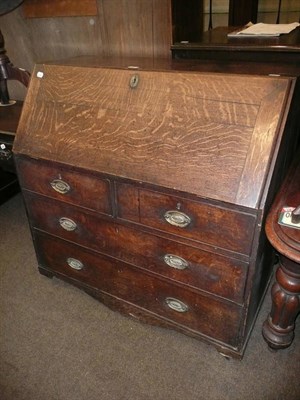 Lot 622 - A George III oak bureau with slope fall front, two short and two long drawers (in poor...