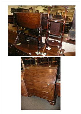 Lot 628 - An Edwardian mahogany cake stand, an oak drop leaf tea trolley and an oak bureau