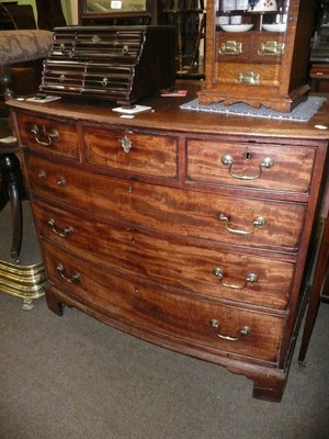 Lot 639 - A George III mahogany bow front chest of three short and three long drawers