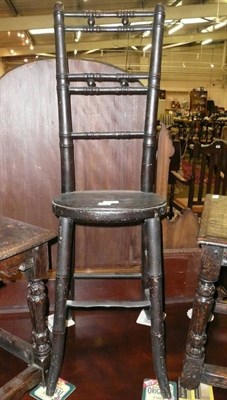 Lot 645 - An early 19th century simulated bamboo deportment chair with oval seat