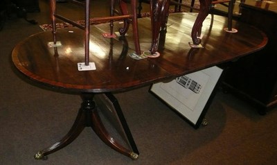 Lot 650 - A reproduction mahogany twin pillar dining table