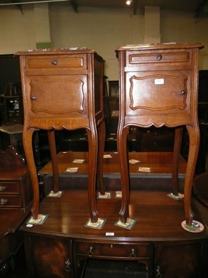 Lot 651 - A pair of pot cupboards with marble tops