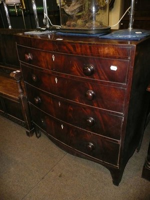 Lot 669 - A Regency mahogany bow front chest of four graduated drawers on bracket feet, turned bun...