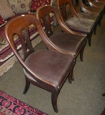 Lot 673 - A set of eight oak early Victorian dining chairs with sabre front supports and curved bucket backs