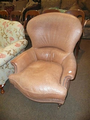 Lot 674 - A leather upholstered spoon back easy chair