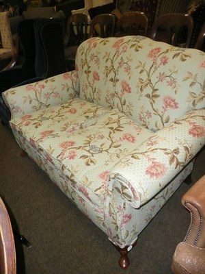 Lot 675 - Small two seater settee upholstered in green floral weave