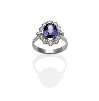 Lot 264 - An 18 Carat White Gold Sapphire and Diamond Cluster Ring, the two tone sapphire of purple and green