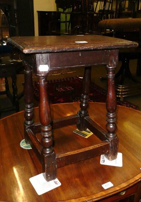 Lot 700 - An 18th century oak small joint stool with later top