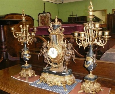 Lot 702 - A marble and brass clock garniature