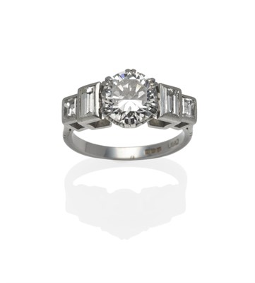 Lot 266 - A Platinum Diamond Solitaire Ring, a round brilliant cut diamond with two graduated step cut...