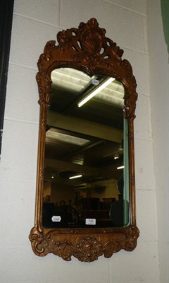 Lot 736 - A Georgian style gilt framed wall mirror with arched foliate moulded pediment