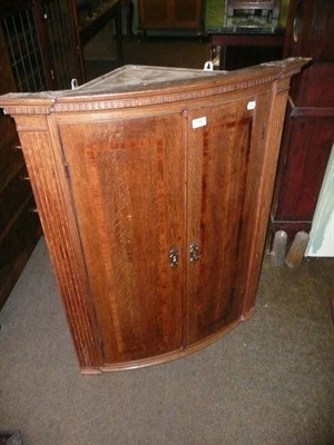 Lot 738 - George III oak hanging corner cupboard