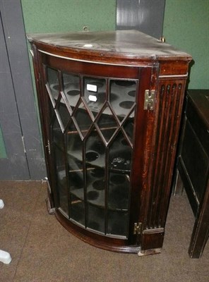 Lot 749 - A glazed mahogany bow front corner cupboard