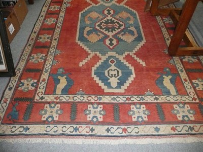 Lot 800 - A Kazak style red ground small carpet