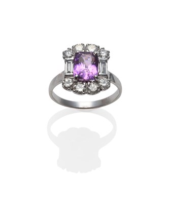 Lot 276 - An 18 Carat White Gold Pink Sapphire and Diamond Cluster Ring, the cushion cut purpley-pink...