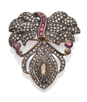 Lot 279 - An Indian Ruby and Diamond Brooch/Pendant, in feather form, set with rose cut diamonds and calibré