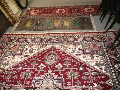 Lot 892 - A modern Persian red ground small carpet and two runners