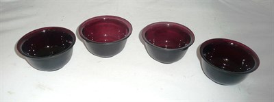 Lot 4 - A set of four aubergine Peking glass bowls, 19th century