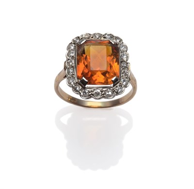 Lot 288 - A Citrine and Diamond Cluster Ring, an octagonal brilliant cut citrine within a border of eight-cut