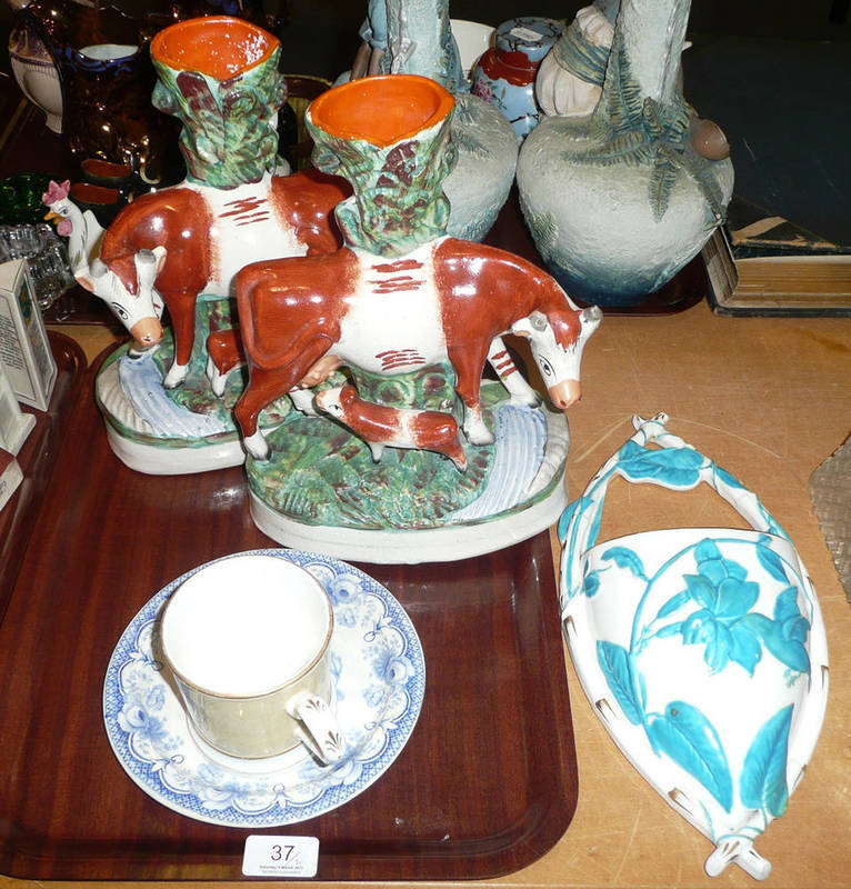 Lot 37 - A pair of Staffordshire cow spill vases, a Victorian porcelain wall pocket, a porcelain mug and...