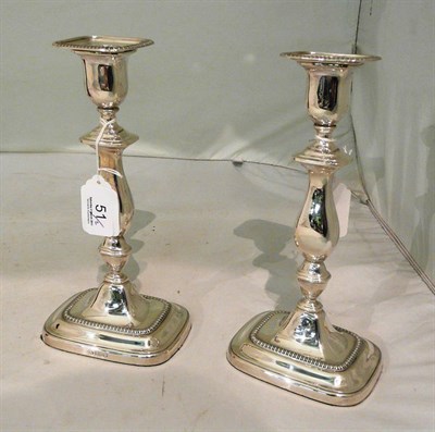 Lot 51 - A pair of loaded silver candlesticks