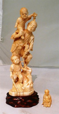Lot 74 - Carved marine ivory figural group and stand and an ivory netsuke