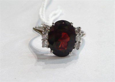 Lot 88 - A 14ct white gold garnet and diamond ring
