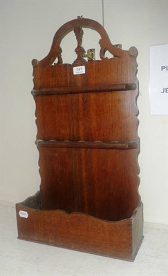 Lot 141 - A late George III oak spoon rack with chess pawn carved and pierced arched top